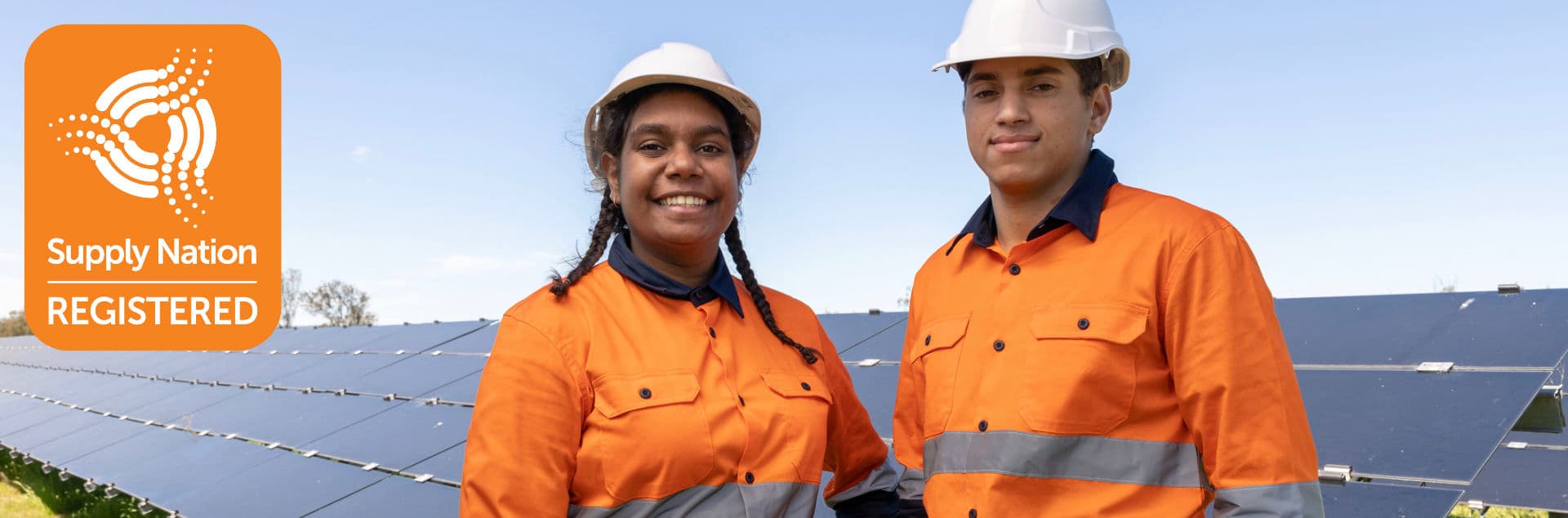 Two First Nations workers in high-vis at a solar farm